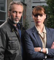 A Touch Of Cloth. Image shows from L to R: Jack Cloth (John Hannah), Anne Oldman (Suranne Jones). Image credit: Zeppotron. A Touch Of Cloth. Image shows from L to R: Jack Cloth (John Hannah), Anne Oldman (Suranne Jones). Image credit: Zeppotron.
