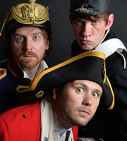 John Finnemore's Souvenir Programme. Image shows from L to R: Simon Kane, John Finnemore, Lawry Lewin. Image credit: British Broadcasting Corporation. John Finnemore's Souvenir Programme. Image shows from L to R: Simon Kane, John Finnemore, Lawry Lewin. Image credit: British Broadcasting Corporation.