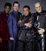 Red Dwarf. Image shows from L to R: Cat (Danny John-Jules), Rimmer (Chris Barrie), Lister (Craig Charles), Kryten (Robert Llewellyn). Image credit: Grant Naylor Productions. Red Dwarf. Image shows from L to R: Cat (Danny John-Jules), Rimmer (Chris Barrie), Lister (Craig Charles), Kryten (Robert Llewellyn). Image credit: Grant Naylor Productions.
