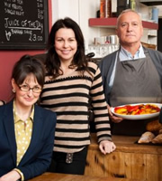 Secrets And Lattes. Image shows from L to R: Clare (Hilary Lyon), Trisha (Julie Graham), Krzysztof (Simon Greenall). Image credit: ABsoLuTeLy Productions. Secrets And Lattes. Image shows from L to R: Clare (Hilary Lyon), Trisha (Julie Graham), Krzysztof (Simon Greenall). Image credit: ABsoLuTeLy Productions.