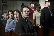 Rev.. Image shows from L to R: Colin Lambert (Steve Evets), Ellie Pattman (Lucy Liemann), Alex Smallbone (Olivia Colman), Rev Adam Smallbone (Tom Hollander), Nigel McCall (Miles Jupp), Adoha Onyeka (Ellen Thomas), Archdeacon Robert (Simon McBurney). Copyright: Big Talk Productions. Rev.. Image shows from L to R: Colin Lambert (Steve Evets), Ellie Pattman (Lucy Liemann), Alex Smallbone (Olivia Colman), Rev Adam Smallbone (Tom Hollander), Nigel McCall (Miles Jupp), Adoha Onyeka (Ellen Thomas), Archdeacon Robert (Simon McBurney). Copyright: Big Talk Productions.