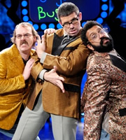 The Angelos Epithemiou Show. Image shows from L to R: Kenny (Seymour Mace), Angelos Epithemiou (Dan Skinner), Gupta (Adeel Akhtar). Copyright: Pett Productions. The Angelos Epithemiou Show. Image shows from L to R: Kenny (Seymour Mace), Angelos Epithemiou (Dan Skinner), Gupta (Adeel Akhtar). Copyright: Pett Productions.