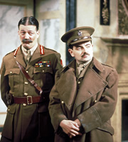 Blackadder. Image shows from L to R: General Melchett (Stephen Fry), Captain Edmund Blackadder (Rowan Atkinson). Copyright: BBC / Tiger Aspect Productions. Blackadder. Image shows from L to R: General Melchett (Stephen Fry), Captain Edmund Blackadder (Rowan Atkinson). Copyright: BBC / Tiger Aspect Productions.