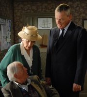 Doc Martin. Image shows from L to R: Mr McLynn (Benjamin Whitrow), Mrs McLynn (Phyllida Law), Dr Martin Ellingham (Martin Clunes). Copyright: Buffalo Pictures / Homerun Productions. Doc Martin. Image shows from L to R: Mr McLynn (Benjamin Whitrow), Mrs McLynn (Phyllida Law), Dr Martin Ellingham (Martin Clunes). Copyright: Buffalo Pictures / Homerun Productions.