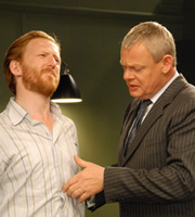 Doc Martin. Image shows from L to R: Mark (Tom Goodman-Hill), Dr Martin Ellingham (Martin Clunes). Copyright: Buffalo Pictures / Homerun Productions. Doc Martin. Image shows from L to R: Mark (Tom Goodman-Hill), Dr Martin Ellingham (Martin Clunes). Copyright: Buffalo Pictures / Homerun Productions.