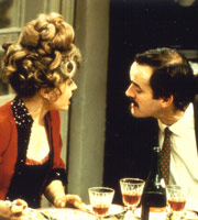 Fawlty Towers. Image shows from L to R: Sybil Fawlty (Prunella Scales), Basil Fawlty (John Cleese). Copyright: BBC. Fawlty Towers. Image shows from L to R: Sybil Fawlty (Prunella Scales), Basil Fawlty (John Cleese). Copyright: BBC.