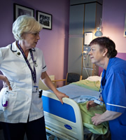 Getting On. Image shows from L to R: Megan Hughes (Helen Griffin), Nurse Kim Wilde (Jo Brand). Copyright: Vera Productions. Getting On. Image shows from L to R: Megan Hughes (Helen Griffin), Nurse Kim Wilde (Jo Brand). Copyright: Vera Productions.