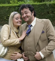 The Green Green Grass. Image shows from L to R: Katia (Morgana Robinson), Bryan (Ivan Kaye). Copyright: Shazam Productions. The Green Green Grass. Image shows from L to R: Katia (Morgana Robinson), Bryan (Ivan Kaye). Copyright: Shazam Productions.