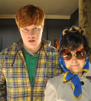 Ideal. Image shows from L to R: Jake (Danny Morgan), Judith (Joanna Neary). Copyright: Baby Cow Productions. Ideal. Image shows from L to R: Jake (Danny Morgan), Judith (Joanna Neary). Copyright: Baby Cow Productions.