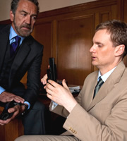 Spy. Image shows from L to R: The Examiner (Robert Lindsay), Tim (Darren Boyd). Copyright: Hat Trick Productions. Spy. Image shows from L to R: The Examiner (Robert Lindsay), Tim (Darren Boyd). Copyright: Hat Trick Productions.