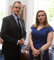 Twenty Twelve. Image shows from L to R: Ian Fletcher (Hugh Bonneville), Siobhan Sharpe (Jessica Hynes). Copyright: BBC. Twenty Twelve. Image shows from L to R: Ian Fletcher (Hugh Bonneville), Siobhan Sharpe (Jessica Hynes). Copyright: BBC.