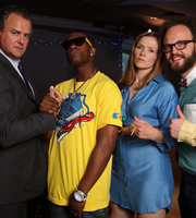 Twenty Twelve. Image shows from L to R: Ian Fletcher (Hugh Bonneville), Mini Steppah (Osy Ikhile), Siobhan Sharpe (Jessica Hynes), Barney Lumsden (Alex Beckett). Copyright: BBC. Twenty Twelve. Image shows from L to R: Ian Fletcher (Hugh Bonneville), Mini Steppah (Osy Ikhile), Siobhan Sharpe (Jessica Hynes), Barney Lumsden (Alex Beckett). Copyright: BBC.