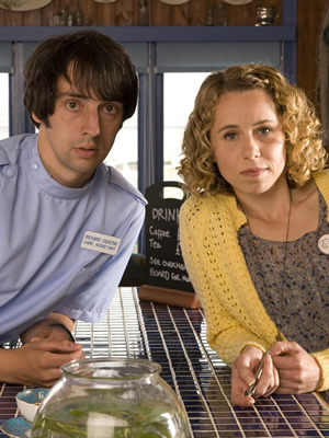 The Café. Image shows from L to R: Richard Dickens (Ralf Little), Sarah Porter (Michelle Terry). Copyright: Jellylegs. The Café. Image shows from L to R: Richard Dickens (Ralf Little), Sarah Porter (Michelle Terry). Copyright: Jellylegs.