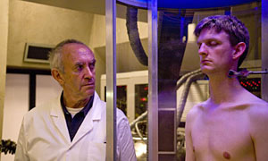 Clone. Image shows from L to R: Dr. Victor Blenkinsop (Jonathan Pryce), Clone (Stuart McLoughlin). Copyright: Roughcut Television. Clone. Image shows from L to R: Dr. Victor Blenkinsop (Jonathan Pryce), Clone (Stuart McLoughlin). Copyright: Roughcut Television.