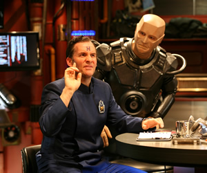 Red Dwarf. Image shows from L to R: Rimmer (Chris Barrie), Kryten (Robert Llewellyn). Copyright: Grant Naylor Productions / BBC. Red Dwarf. Image shows from L to R: Rimmer (Chris Barrie), Kryten (Robert Llewellyn). Copyright: Grant Naylor Productions / BBC.
