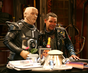 Red Dwarf. Image shows from L to R: Kryten (Robert Llewellyn), Lister (Craig Charles). Copyright: Grant Naylor Productions / BBC. Red Dwarf. Image shows from L to R: Kryten (Robert Llewellyn), Lister (Craig Charles). Copyright: Grant Naylor Productions / BBC.