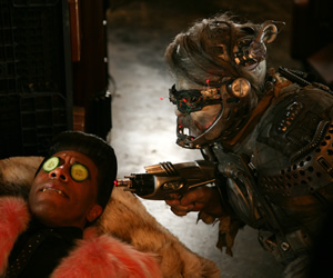 Red Dwarf. Image shows from L to R: Cat (Danny John-Jules), Hogey the Roguey (Richard O'Callaghan). Copyright: Grant Naylor Productions / BBC. Red Dwarf. Image shows from L to R: Cat (Danny John-Jules), Hogey the Roguey (Richard O'Callaghan). Copyright: Grant Naylor Productions / BBC.