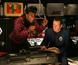 Red Dwarf. Image shows from L to R: Cat (Danny John-Jules), Rimmer (Chris Barrie). Copyright: Grant Naylor Productions / BBC. Red Dwarf. Image shows from L to R: Cat (Danny John-Jules), Rimmer (Chris Barrie). Copyright: Grant Naylor Productions / BBC.