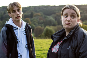 This Country. Image shows from L to R: Lee 'Kurtan' Mucklowe (Charlie Cooper), Kerry Mucklowe (Daisy May Cooper). Copyright: BBC. This Country. Image shows from L to R: Lee 'Kurtan' Mucklowe (Charlie Cooper), Kerry Mucklowe (Daisy May Cooper). Copyright: BBC.