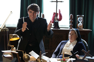 Derry Girls. Image shows from L to R: Father Peter (Peter Campion), Sister Michael (Siobhán McSweeney). Copyright: Hat Trick Productions. Derry Girls. Image shows from L to R: Father Peter (Peter Campion), Sister Michael (Siobhán McSweeney). Copyright: Hat Trick Productions.
