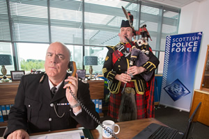 Scot Squad. Image shows from L to R: Chief Commissioner Cameron Miekelson (Jack Docherty), Unknown. Copyright: The Comedy Unit. Scot Squad. Image shows from L to R: Chief Commissioner Cameron Miekelson (Jack Docherty), Unknown. Copyright: The Comedy Unit.