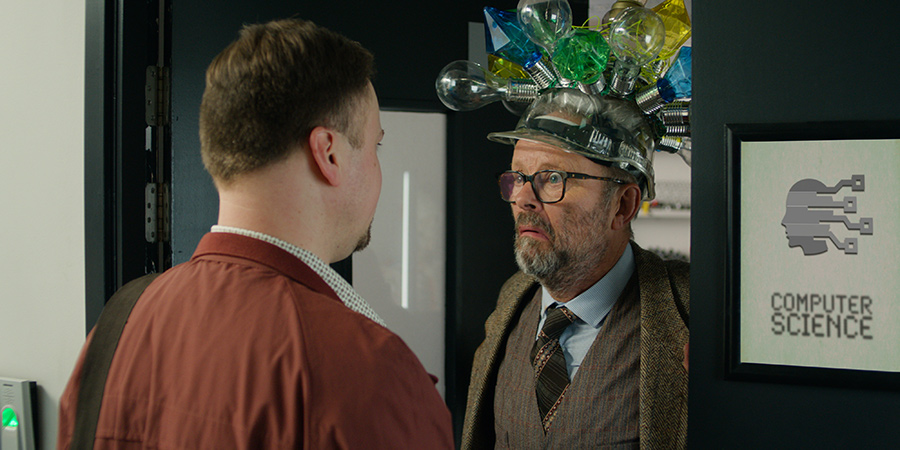 Ashens And The Polybius Heist. Image shows from L to R: Ashens (Stuart Ashen), The Professor (Robert Llewellyn). Ashens And The Polybius Heist. Image shows from L to R: Ashens (Stuart Ashen), The Professor (Robert Llewellyn).