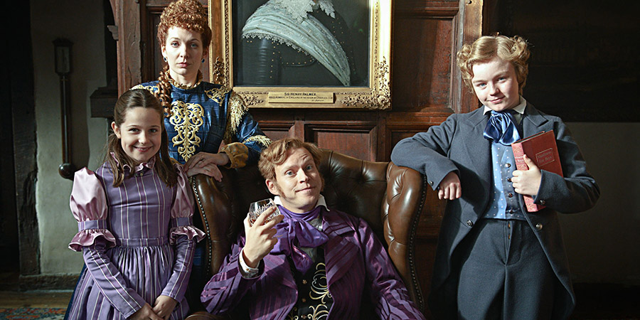 The Bleak Old Shop Of Stuff. Image shows from L to R: Victoria Secret-Past (Ambra Lily Keegan), Conceptiva Secret-Past (Katherine Parkinson), Jedrington Secret-Past (Robert Webb), Victor Secret-Past (Finlay Christie). Copyright: BBC. The Bleak Old Shop Of Stuff. Image shows from L to R: Victoria Secret-Past (Ambra Lily Keegan), Conceptiva Secret-Past (Katherine Parkinson), Jedrington Secret-Past (Robert Webb), Victor Secret-Past (Finlay Christie). Copyright: BBC.