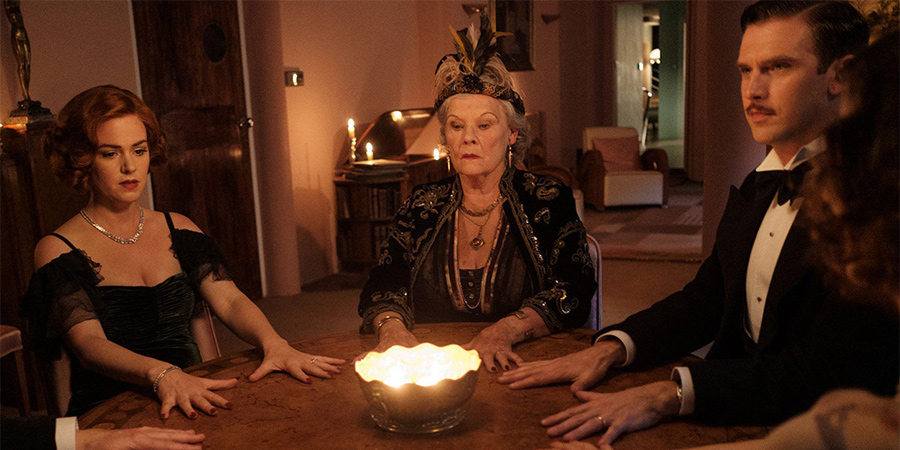 Blithe Spirit. Image shows from L to R: Ruth Condomine (Isla Fisher), Madame Cecily Arcati (Judi Dench), Charles Condomine (Dan Stevens). Blithe Spirit. Image shows from L to R: Ruth Condomine (Isla Fisher), Madame Cecily Arcati (Judi Dench), Charles Condomine (Dan Stevens).