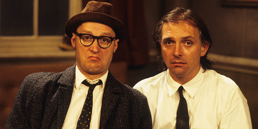 Bottom. Image shows from L to R: Eddie Hitler (Adrian Edmondson), Richie Richard (Rik Mayall). Copyright: BBC. Bottom. Image shows from L to R: Eddie Hitler (Adrian Edmondson), Richie Richard (Rik Mayall). Copyright: BBC.
