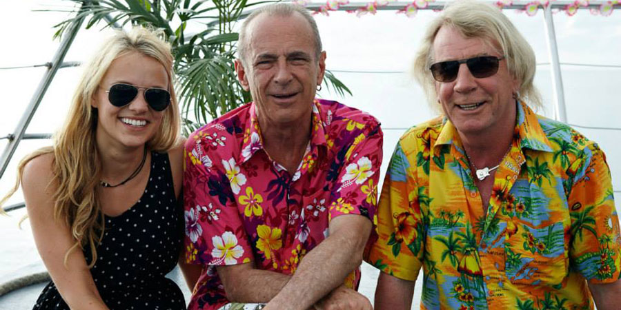 Bula Quo!. Image shows from L to R: Caroline (Laura Aikman), Francis (Francis Rossi), Rick (Rick Parfitt). Copyright: Status Quo Films. Bula Quo!. Image shows from L to R: Caroline (Laura Aikman), Francis (Francis Rossi), Rick (Rick Parfitt). Copyright: Status Quo Films.
