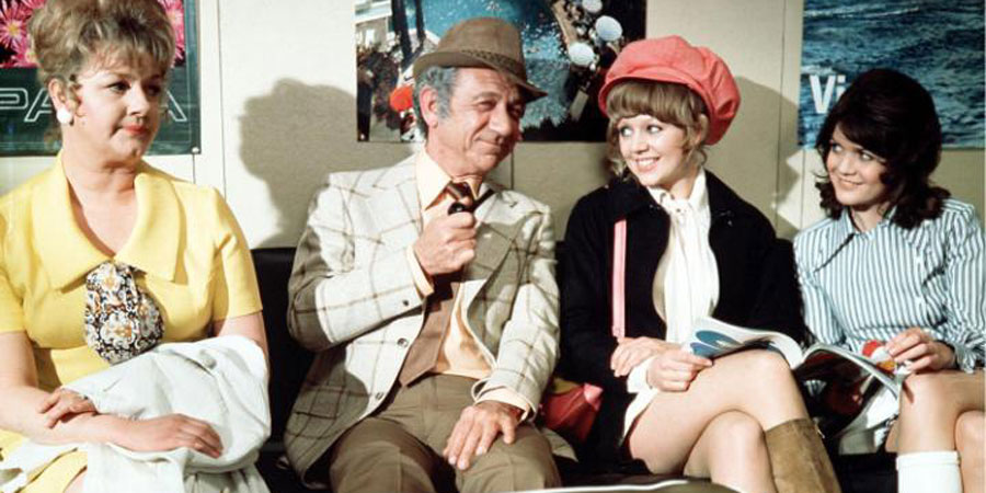 Carry On Abroad. Image shows from L to R: Cora Flange (Joan Sims), Vic Flange (Sid James), Marge (Carol Hawkins), Lily Mays (Sally Geeson). Copyright: Peter Rogers Productions. Carry On Abroad. Image shows from L to R: Cora Flange (Joan Sims), Vic Flange (Sid James), Marge (Carol Hawkins), Lily Mays (Sally Geeson). Copyright: Peter Rogers Productions.