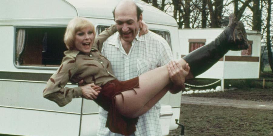 Carry On Behind. Image shows from L to R: Professor Anna Vooshka (Elke Sommer), Arthur Upmore (Bernard Bresslaw). Copyright: Peter Rogers Productions. Carry On Behind. Image shows from L to R: Professor Anna Vooshka (Elke Sommer), Arthur Upmore (Bernard Bresslaw). Copyright: Peter Rogers Productions.