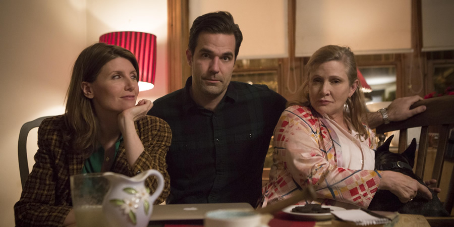 Catastrophe. Image shows from L to R: Sharon (Sharon Horgan), Rob (Rob Delaney), Mia (Carrie Fisher). Copyright: Avalon Television. Catastrophe. Image shows from L to R: Sharon (Sharon Horgan), Rob (Rob Delaney), Mia (Carrie Fisher). Copyright: Avalon Television.