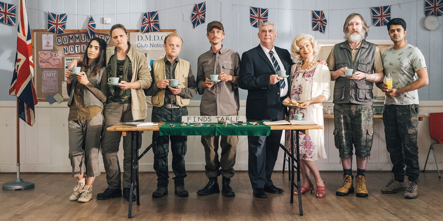 Detectorists. Image shows from L to R: Varde (Orion Ben), Louise (Laura Checkley), Lance Stater (Toby Jones), Andy Stone (Mackenzie Crook), Terry (Gerard Horan), Sheila (Sophie Thompson), Russell (Pearce Quigley), Hugh (Divian Ladwa). Detectorists. Image shows from L to R: Varde (Orion Ben), Louise (Laura Checkley), Lance Stater (Toby Jones), Andy Stone (Mackenzie Crook), Terry (Gerard Horan), Sheila (Sophie Thompson), Russell (Pearce Quigley), Hugh (Divian Ladwa).