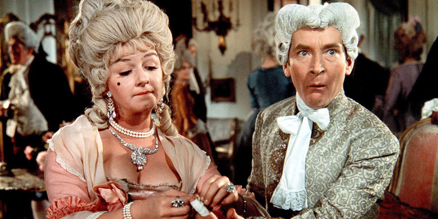 Don't Lose Your Head. Image shows from L to R: Desiree Dubarry (Joan Sims), Citizen Camembert (Kenneth Williams). Copyright: Peter Rogers Productions. Don't Lose Your Head. Image shows from L to R: Desiree Dubarry (Joan Sims), Citizen Camembert (Kenneth Williams). Copyright: Peter Rogers Productions.