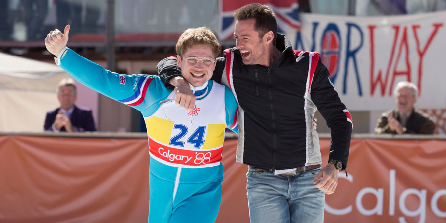 Eddie The Eagle. Image shows from L to R: Michael 'Eddie' Edwards (Taron Egerton), Bronson Peary (Hugh Jackman). Eddie The Eagle. Image shows from L to R: Michael 'Eddie' Edwards (Taron Egerton), Bronson Peary (Hugh Jackman).