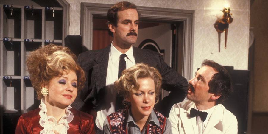 Fawlty Towers. Image shows from L to R: Sybil Fawlty (Prunella Scales), Basil Fawlty (John Cleese), Polly (Connie Booth), Manuel (Andrew Sachs). Copyright: BBC. Fawlty Towers. Image shows from L to R: Sybil Fawlty (Prunella Scales), Basil Fawlty (John Cleese), Polly (Connie Booth), Manuel (Andrew Sachs). Copyright: BBC.
