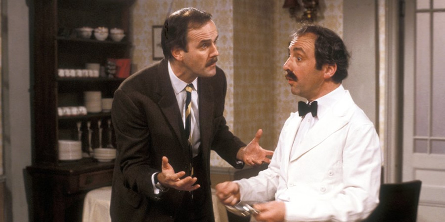 Fawlty Towers. Image shows from L to R: Basil Fawlty (John Cleese), Manuel (Andrew Sachs). Copyright: BBC. Fawlty Towers. Image shows from L to R: Basil Fawlty (John Cleese), Manuel (Andrew Sachs). Copyright: BBC.