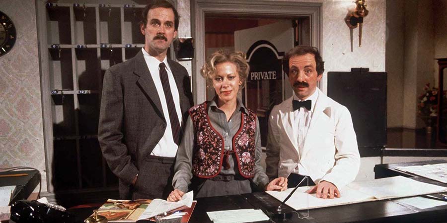 Fawlty Towers. Image shows from L to R: Basil Fawlty (John Cleese), Polly (Connie Booth), Manuel (Andrew Sachs). Copyright: BBC. Fawlty Towers. Image shows from L to R: Basil Fawlty (John Cleese), Polly (Connie Booth), Manuel (Andrew Sachs). Copyright: BBC.