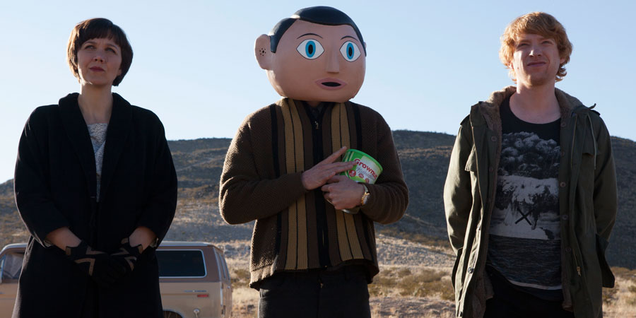 Frank. Image shows from L to R: Clara (Maggie Gyllenhaal), Frank Sidebottom (Michael Fassbender), Jon Burroughs (Domhnall Gleeson). Copyright: Film4. Frank. Image shows from L to R: Clara (Maggie Gyllenhaal), Frank Sidebottom (Michael Fassbender), Jon Burroughs (Domhnall Gleeson). Copyright: Film4.