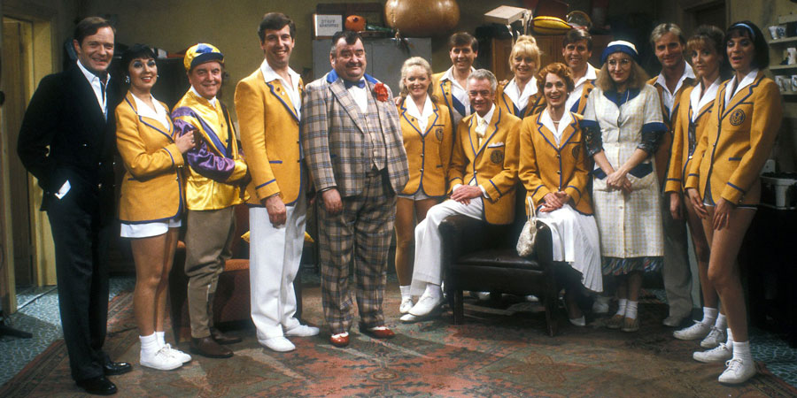 Hi-De-Hi!. Image shows from L to R: Sqdn-Ldr Clive Dempster DFC (David Griffin), Gladys Pugh (Ruth Madoc), Fred Quilly (Felix Bowness), Spike Dixon (Jeffrey Holland), Ted Bovis (Paul Shane), April Wingate (Linda Regan), Stanley Matthews (David Webb), Barry Stuart-Hargreaves (Barry Howard), Sylvia Garnsey (Nikki Kelly), Yvonne Stuart-Hargreaves (Diane Holland), Bruce Matthews (Tony Webb), Peggy Ollerenshaw (Su Pollard), Gary Bolton (Chris Andrews), Unknown, Dawn Freshwater (Laura Jackson). Copyright: BBC. Hi-De-Hi!. Image shows from L to R: Sqdn-Ldr Clive Dempster DFC (David Griffin), Gladys Pugh (Ruth Madoc), Fred Quilly (Felix Bowness), Spike Dixon (Jeffrey Holland), Ted Bovis (Paul Shane), April Wingate (Linda Regan), Stanley Matthews (David Webb), Barry Stuart-Hargreaves (Barry Howard), Sylvia Garnsey (Nikki Kelly), Yvonne Stuart-Hargreaves (Diane Holland), Bruce Matthews (Tony Webb), Peggy Ollerenshaw (Su Pollard), Gary Bolton (Chris Andrews), Unknown, Dawn Freshwater (Laura Jackson). Copyright: BBC.