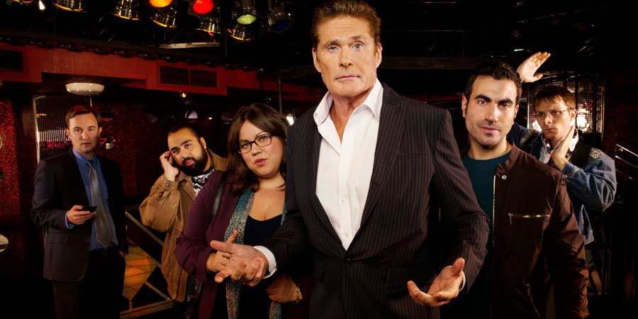Hoff The Record. Image shows from L to R: Max Coleman (Fergus Craig), Terry Patel (Asim Chaudhry), Harriet Fitzgerald (Ella Smith), Hoff (David Hasselhoff), Danny Jones (Brett Goldstein), Dieter Hasselhoff (Mark Quartley). Copyright: Me & You Productions. Hoff The Record. Image shows from L to R: Max Coleman (Fergus Craig), Terry Patel (Asim Chaudhry), Harriet Fitzgerald (Ella Smith), Hoff (David Hasselhoff), Danny Jones (Brett Goldstein), Dieter Hasselhoff (Mark Quartley). Copyright: Me & You Productions.