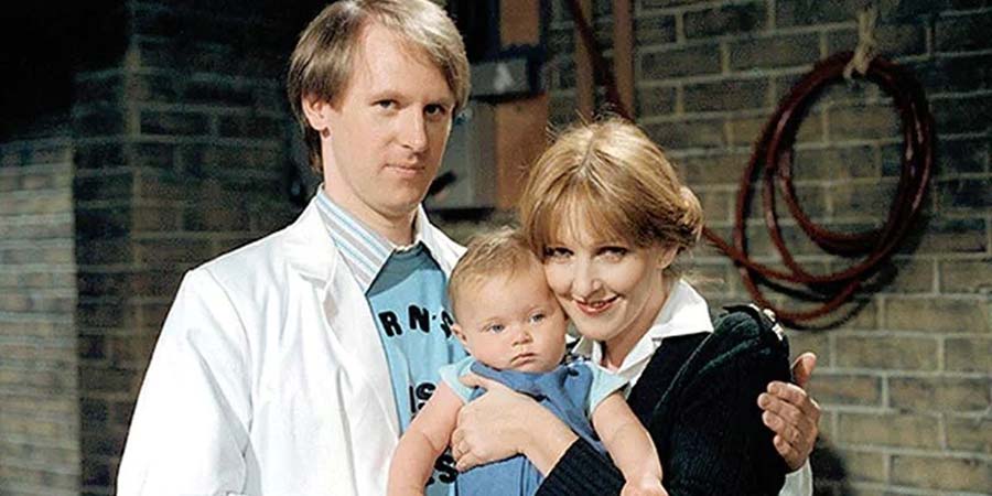 Holding The Fort. Image shows from L to R: Russell Milburn (Peter Davison), Unknown, Penny Milburn (Patricia Hodge). Copyright: London Weekend Television. Holding The Fort. Image shows from L to R: Russell Milburn (Peter Davison), Unknown, Penny Milburn (Patricia Hodge). Copyright: London Weekend Television.