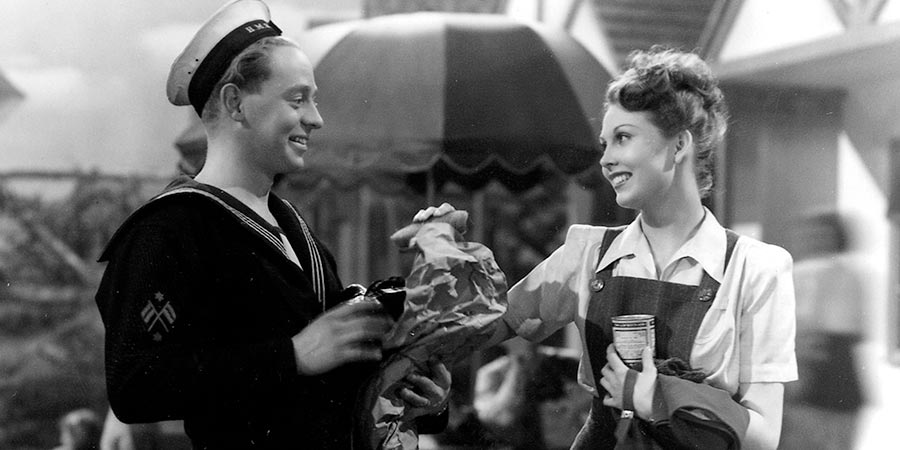 Holiday Camp. Image shows from L to R: Jimmy Gardner (Jimmy Hanley), Joan Huggett (Hazel Court). Copyright: Gainsborough Pictures 1928 Limited. Holiday Camp. Image shows from L to R: Jimmy Gardner (Jimmy Hanley), Joan Huggett (Hazel Court). Copyright: Gainsborough Pictures 1928 Limited.