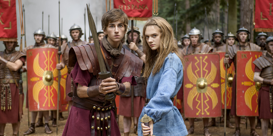 Horrible Histories: The Movie - Rotten Romans. Image shows from L to R: Atti (Sebastian Croft), Orla (Emilia Jones). Copyright: Nick Wall. Horrible Histories: The Movie - Rotten Romans. Image shows from L to R: Atti (Sebastian Croft), Orla (Emilia Jones). Copyright: Nick Wall.