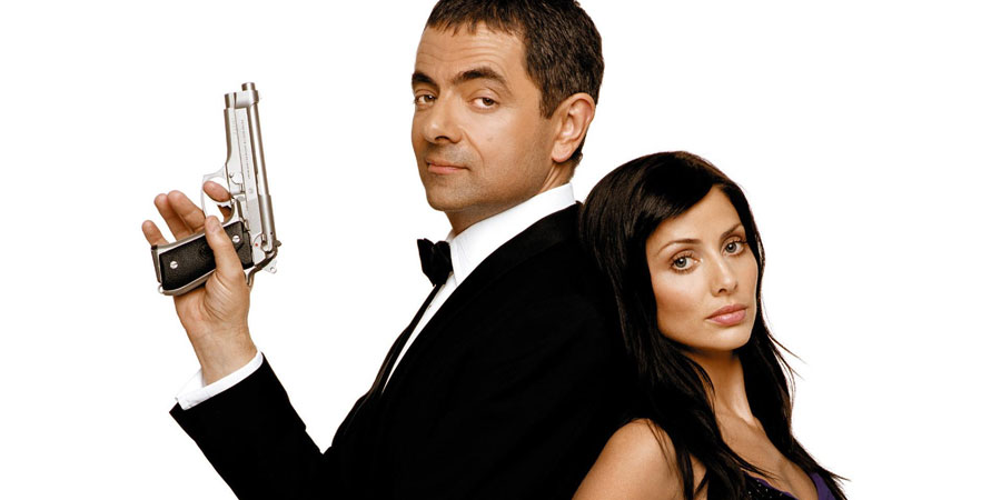 Johnny English. Image shows from L to R: Johnny English (Rowan Atkinson), Lorna Campbell (Natalie Imbruglia). Copyright: Working Title Films / STUDIOCANAL. Johnny English. Image shows from L to R: Johnny English (Rowan Atkinson), Lorna Campbell (Natalie Imbruglia). Copyright: Working Title Films / STUDIOCANAL.