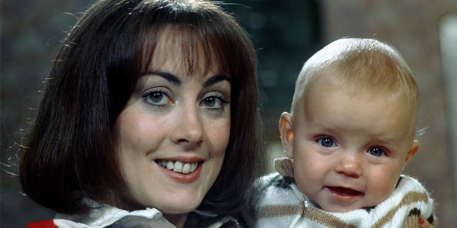 Miss Jones And Son. Image shows from L to R: Elizabeth Jones (Paula Wilcox), Baby Roland (Luke Steensil). Copyright: Thames Television. Miss Jones And Son. Image shows from L to R: Elizabeth Jones (Paula Wilcox), Baby Roland (Luke Steensil). Copyright: Thames Television.
