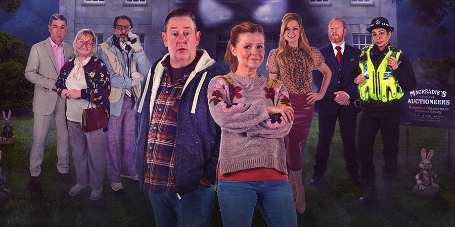 Murder, They Hope. Image shows from L to R: Clive (James Lance), Betty the Beast (Janine Duvitski), Carl (Nitin Ganatra), Terry (Johnny Vegas), Gemma (Sian Gibson), Monica (Sarah Hadland), Jacob (Adrian Scarborough), Vicky (Shobna Gulati). Copyright: Shiny Button Productions. Murder, They Hope. Image shows from L to R: Clive (James Lance), Betty the Beast (Janine Duvitski), Carl (Nitin Ganatra), Terry (Johnny Vegas), Gemma (Sian Gibson), Monica (Sarah Hadland), Jacob (Adrian Scarborough), Vicky (Shobna Gulati). Copyright: Shiny Button Productions.