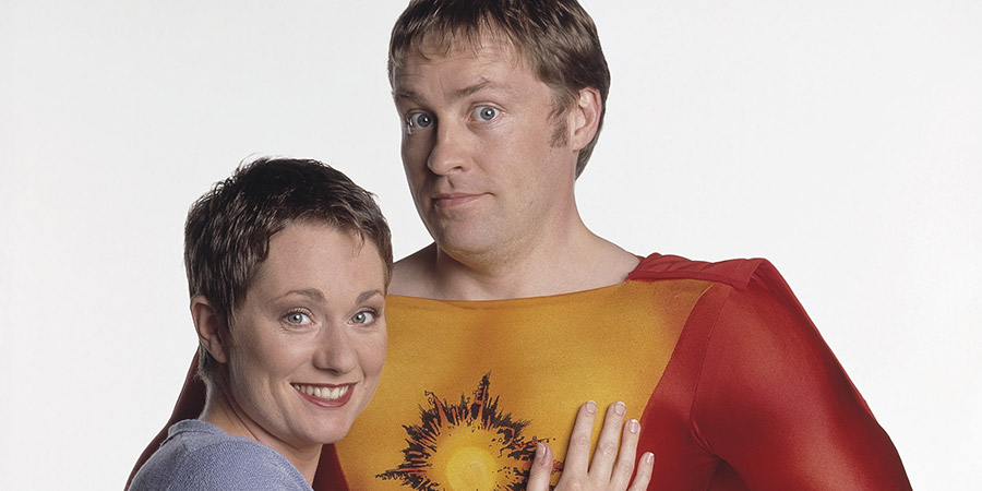 My Hero. Image shows from L to R: Janet Dawkins (Emily Joyce), George Sunday (Ardal O'Hanlon). Copyright: Big Bear Films. My Hero. Image shows from L to R: Janet Dawkins (Emily Joyce), George Sunday (Ardal O'Hanlon). Copyright: Big Bear Films.