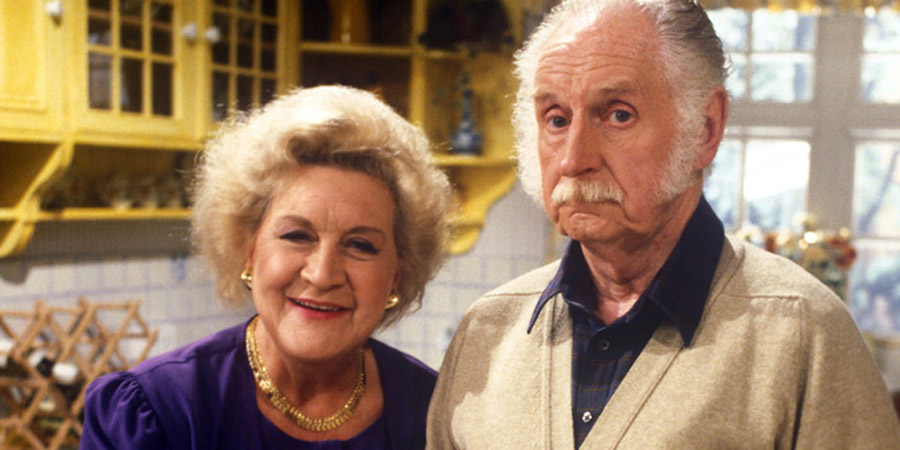 My Husband And I. Image shows from L to R: Nora Powers (Mollie Sugden), George Powers (William Moore). Copyright: Yorkshire Television. My Husband And I. Image shows from L to R: Nora Powers (Mollie Sugden), George Powers (William Moore). Copyright: Yorkshire Television.